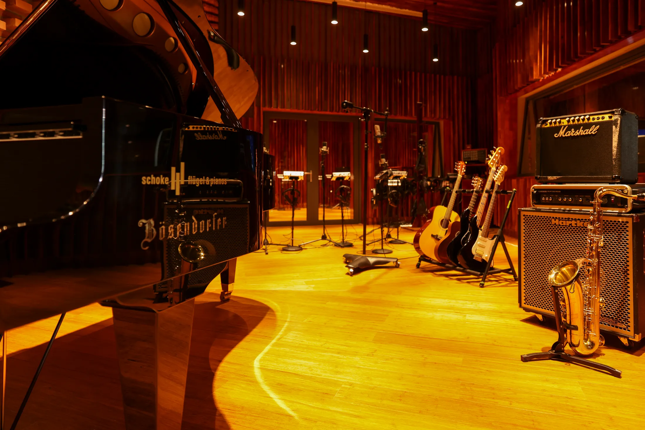 The live room, with a Bösendorfer grand piano, guitars and amps ready on the warm wooden floor